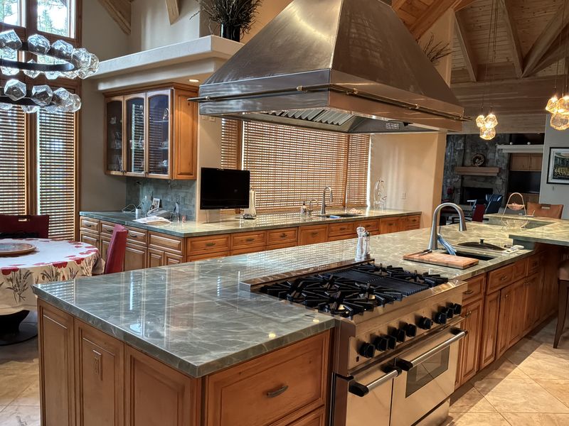 Quartzite island with a range and stainless hood