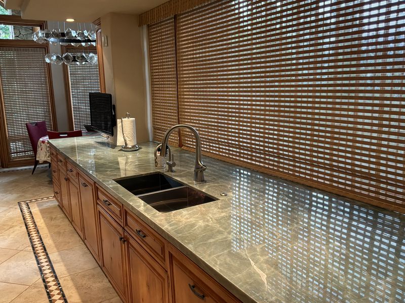 Long quartzite perimeter counter with undermount double sink
